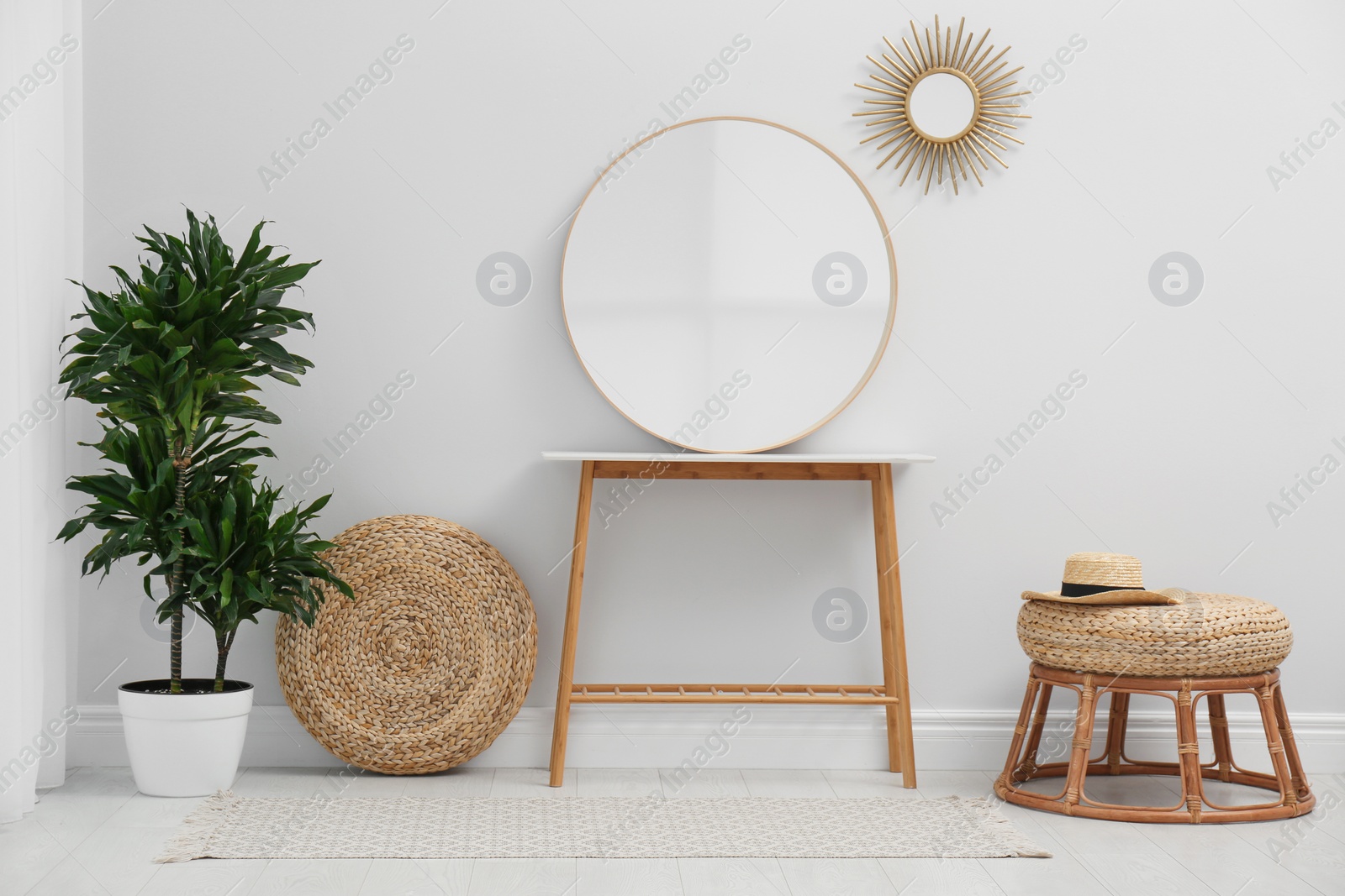 Photo of Stylish round mirror near white wall in room