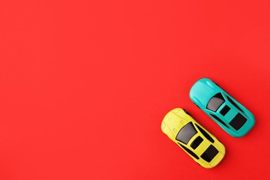 Photo of Different bright cars on red background, flat lay. Space for text