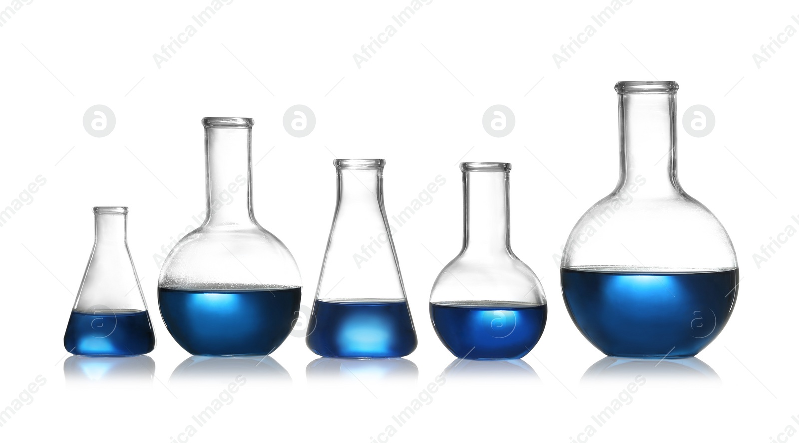 Photo of Group of chemistry glassware with liquid samples isolated on white