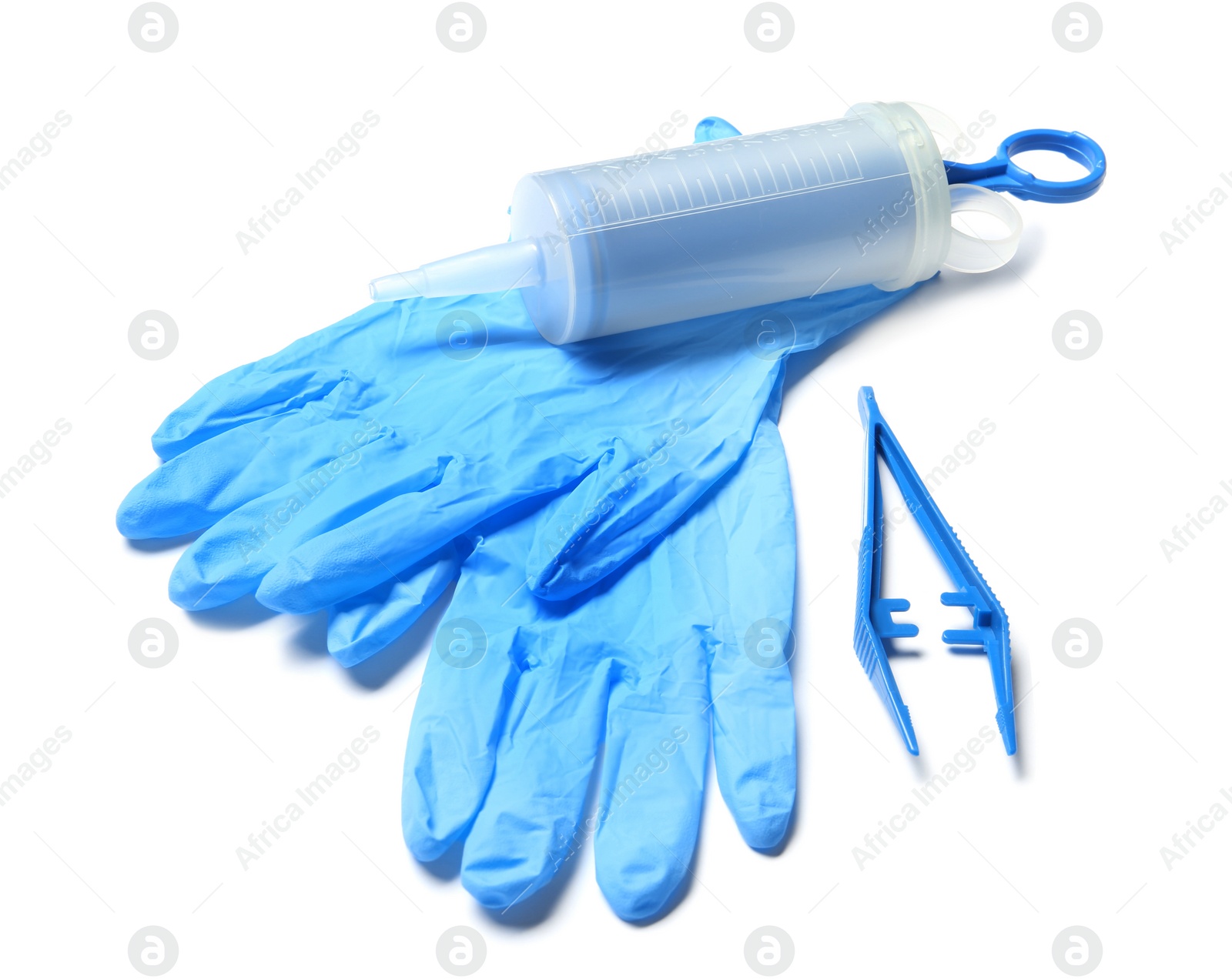 Photo of Medical gloves, disposable forceps and syringe on white background