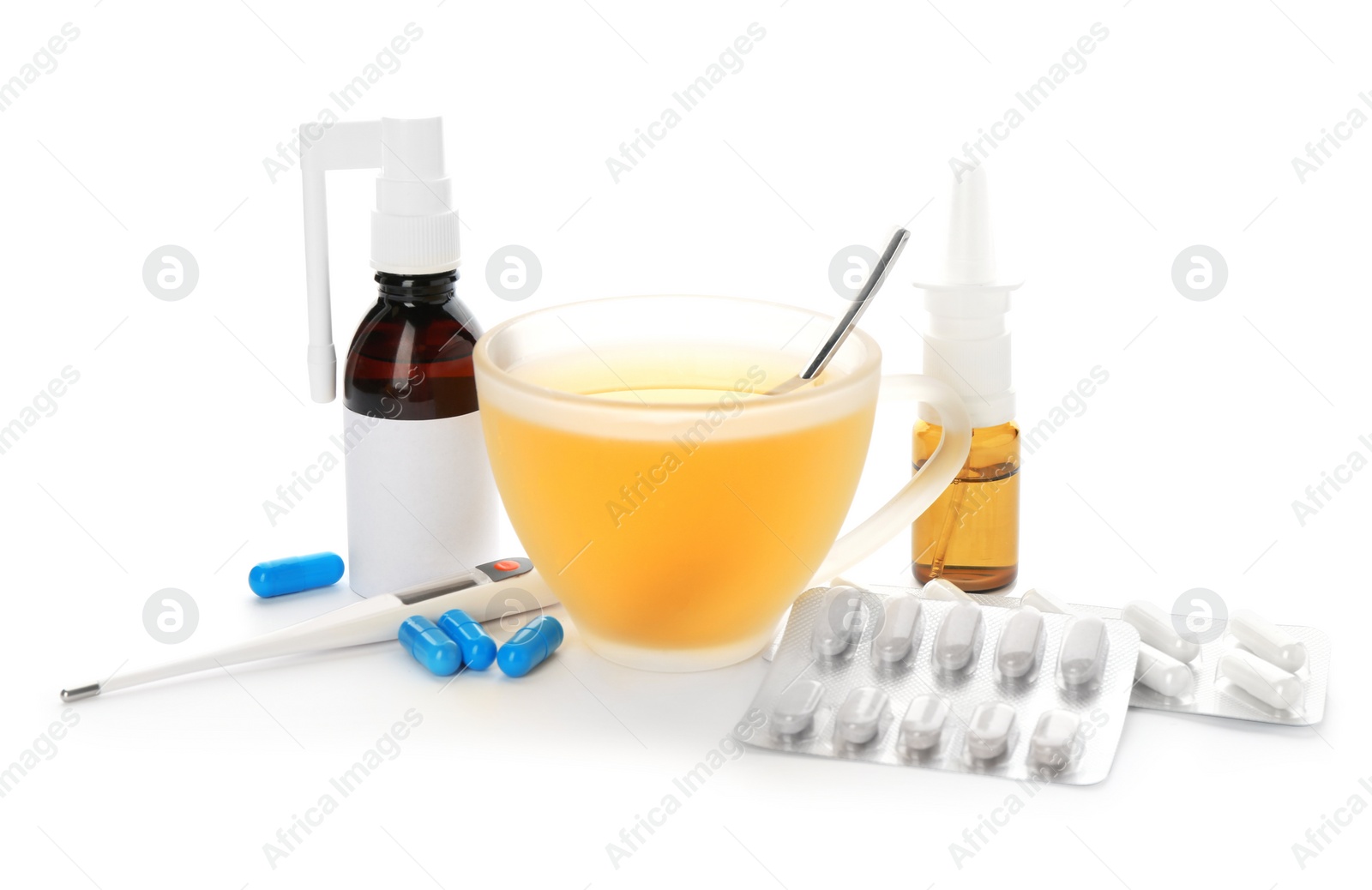 Photo of Cup with hot tea, pills and drugs for cold on white background