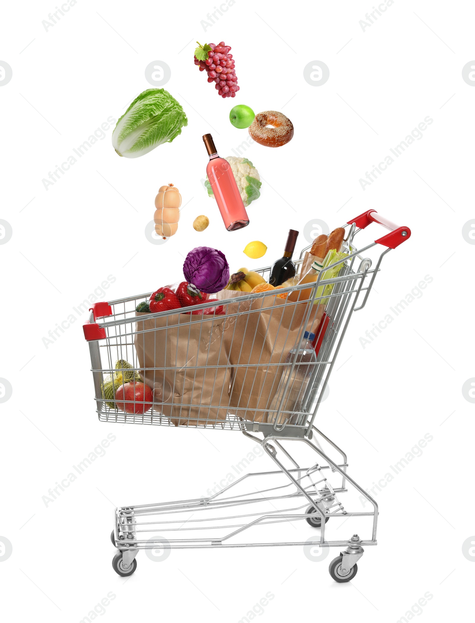 Image of Market assortment. Different products falling into shopping cart on white background