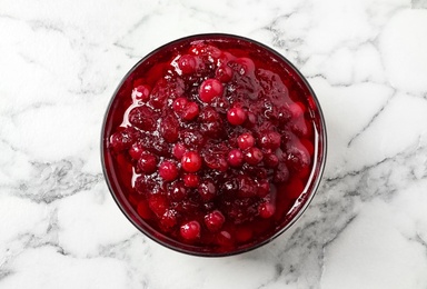 Photo of Cranberry sauce on white marble table, top view