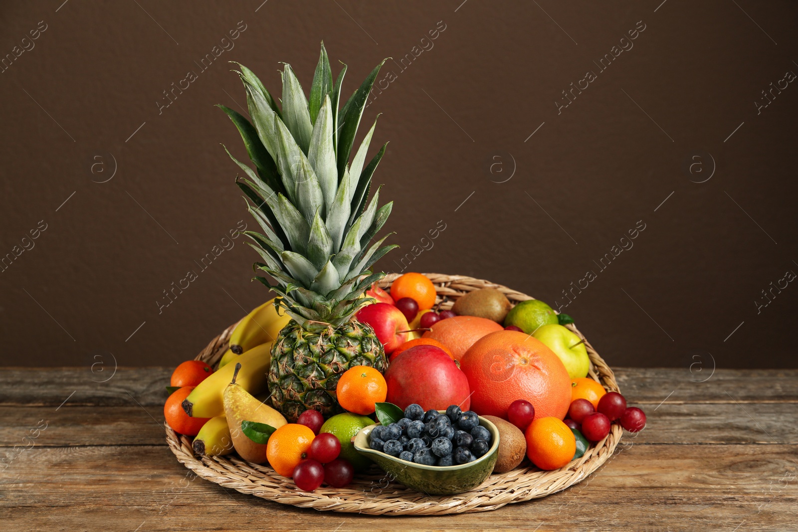 Photo of Assortment of fresh exotic fruits on wooden table