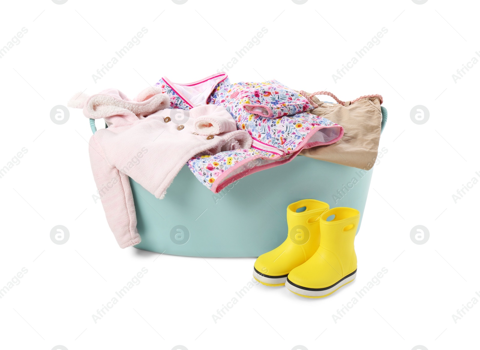 Photo of Laundry basket with baby clothes and rubber boots isolated on white