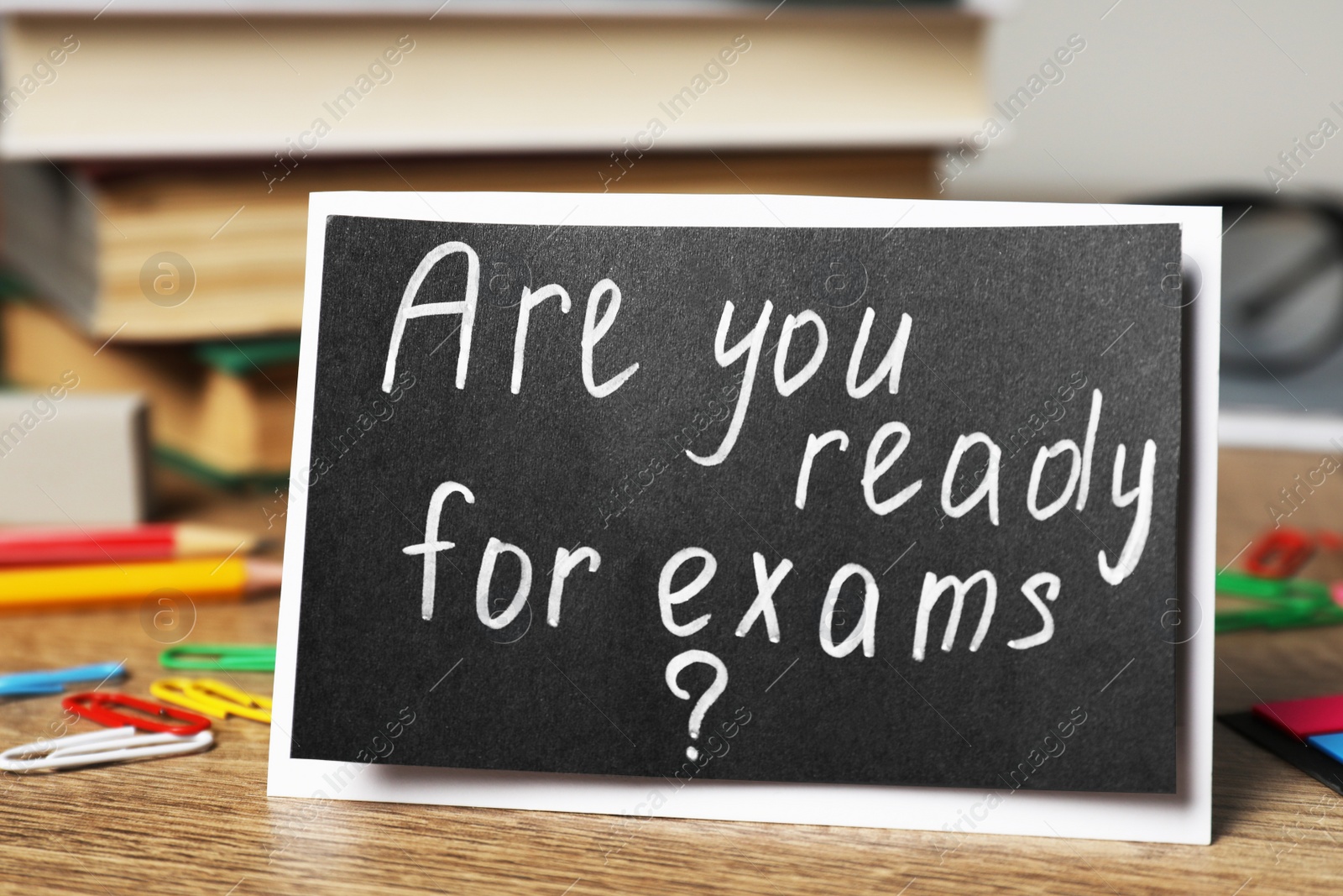 Photo of Card with question Are You Ready For Exams? on wooden table