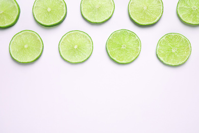 Juicy fresh lime slices on white background, top view