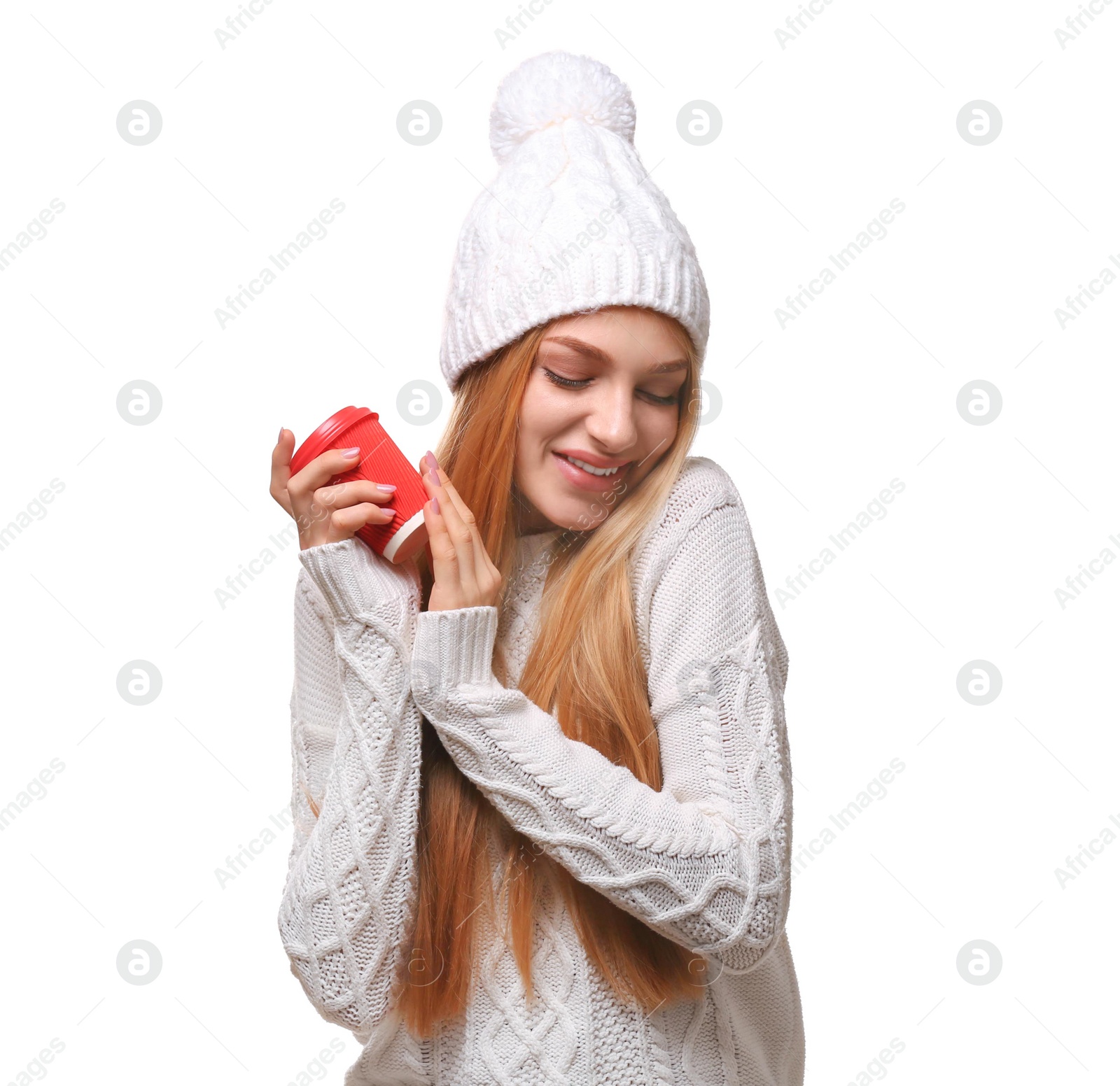 Photo of Portrait of young woman in stylish hat and sweater with coffee paper cup on white background. Winter atmosphere