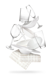 Image of Set of clean tableware and napkin in flight on white background