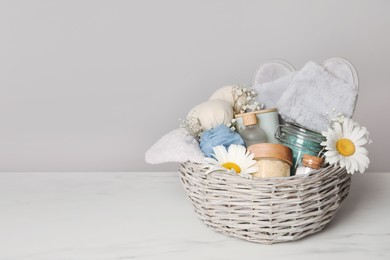 Spa gift set with different personal care products on white marble table. Space for text