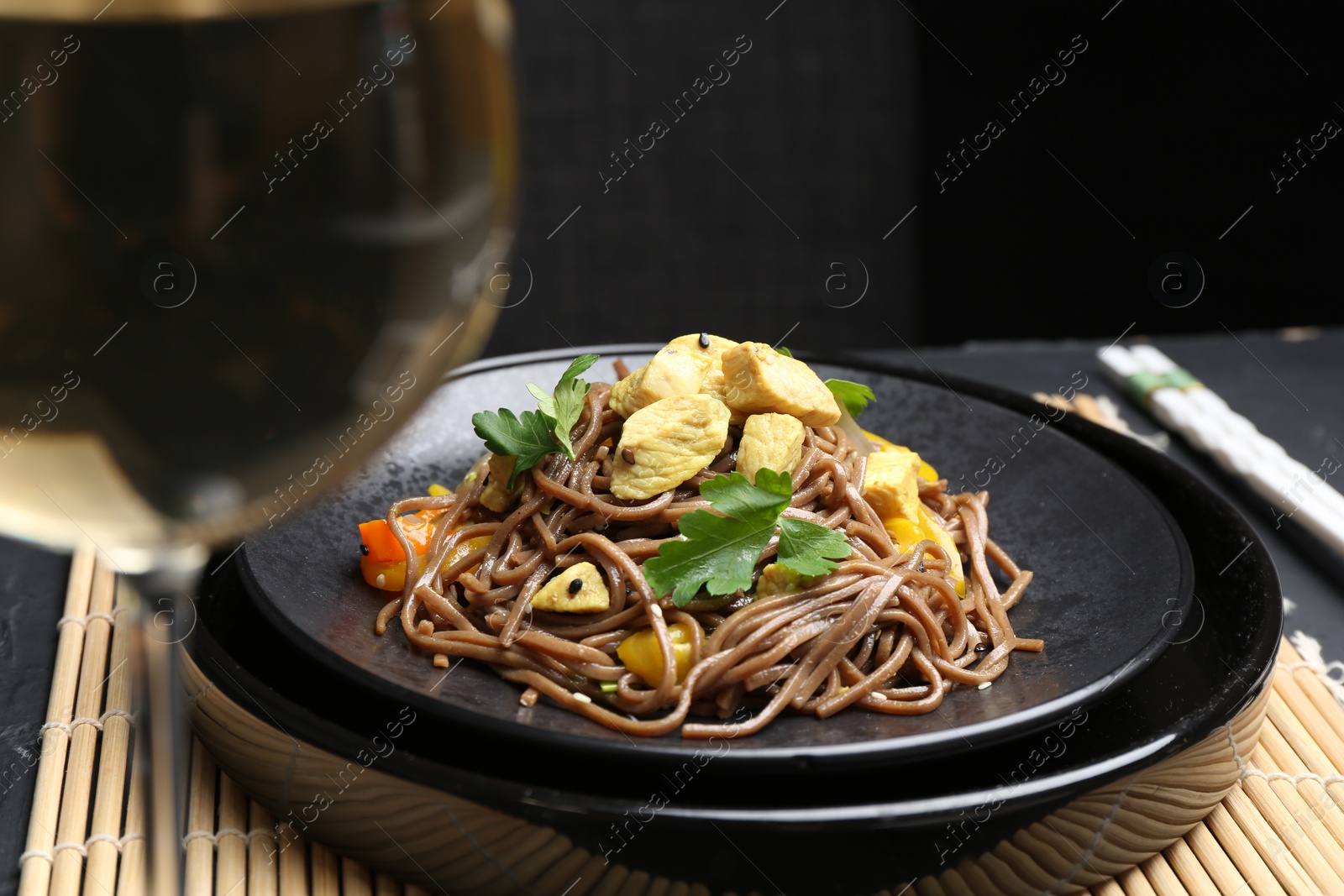 Photo of Stir-fry. Tasty noodles with meat and vegetables served on table