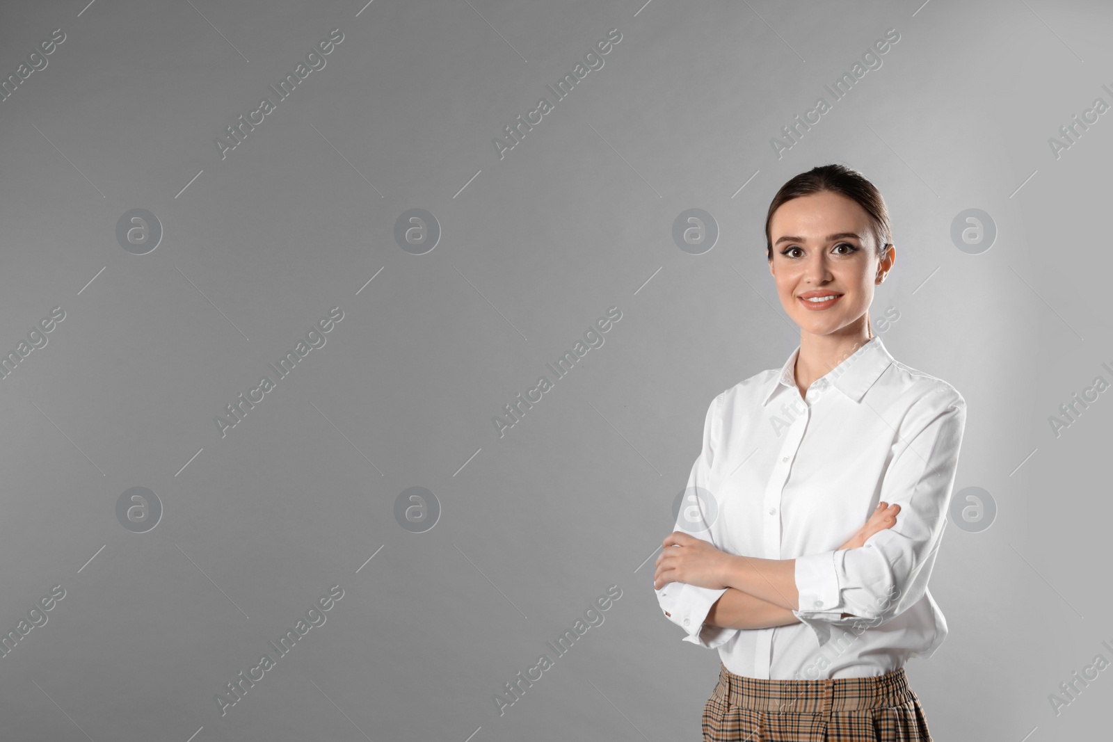 Photo of Portrait of young female teacher on grey background. Space for text