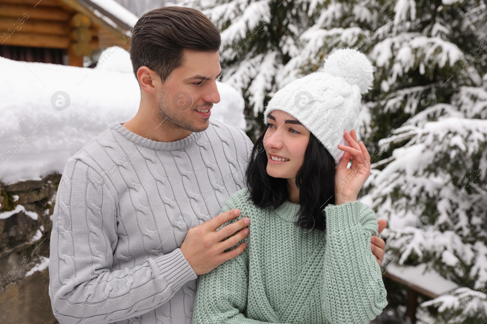 Photo of Happy couple in warm sweaters outdoors on winter day