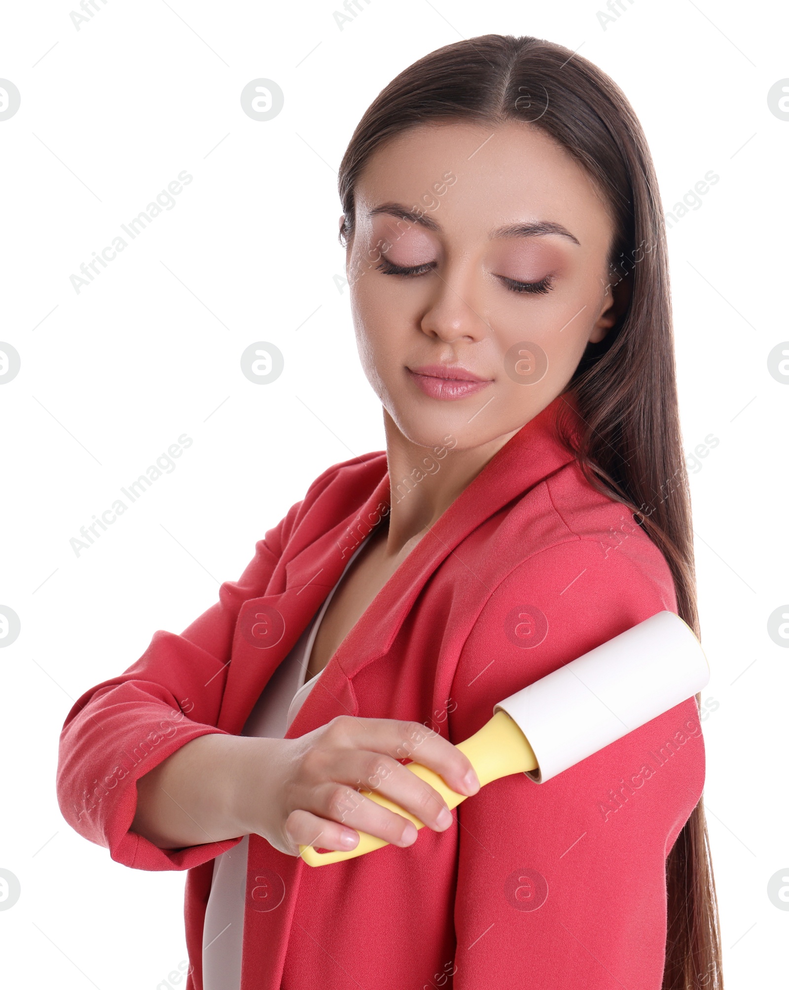 Photo of Young woman cleaning clothes with lint roller on white background