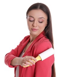 Young woman cleaning clothes with lint roller on white background