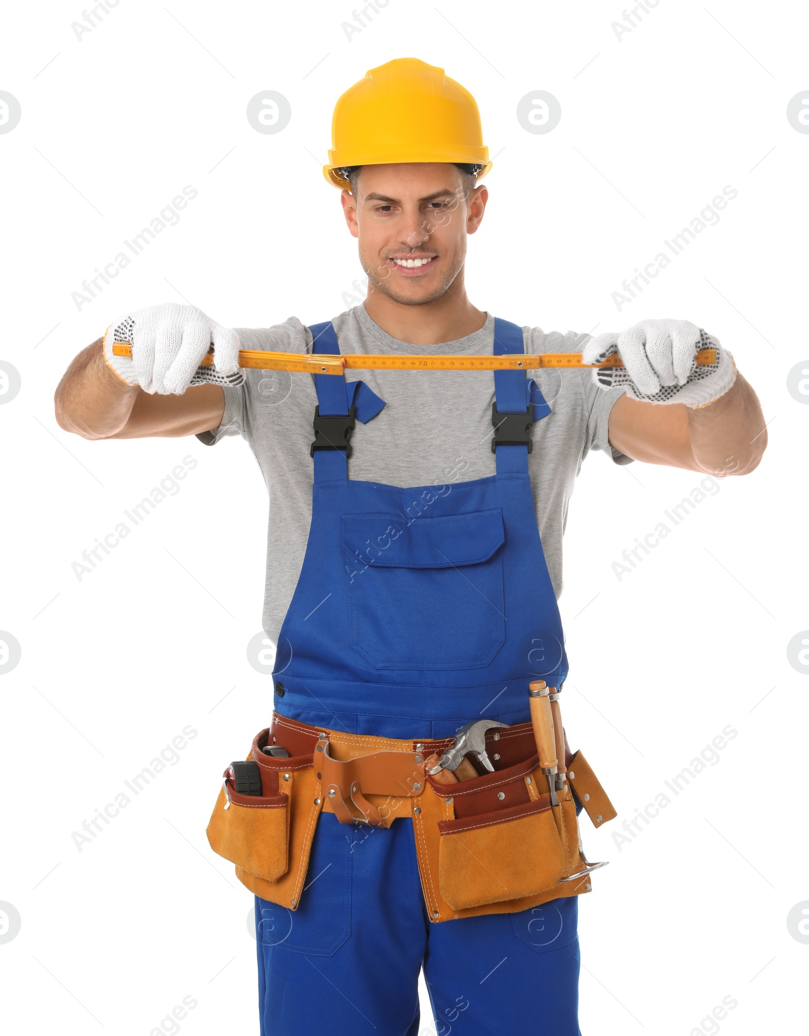 Photo of Handsome carpenter with folding rule isolated on white