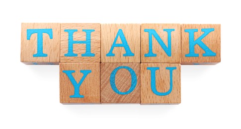 Phrase Thank You made of wooden cubes with letters on white background, top view