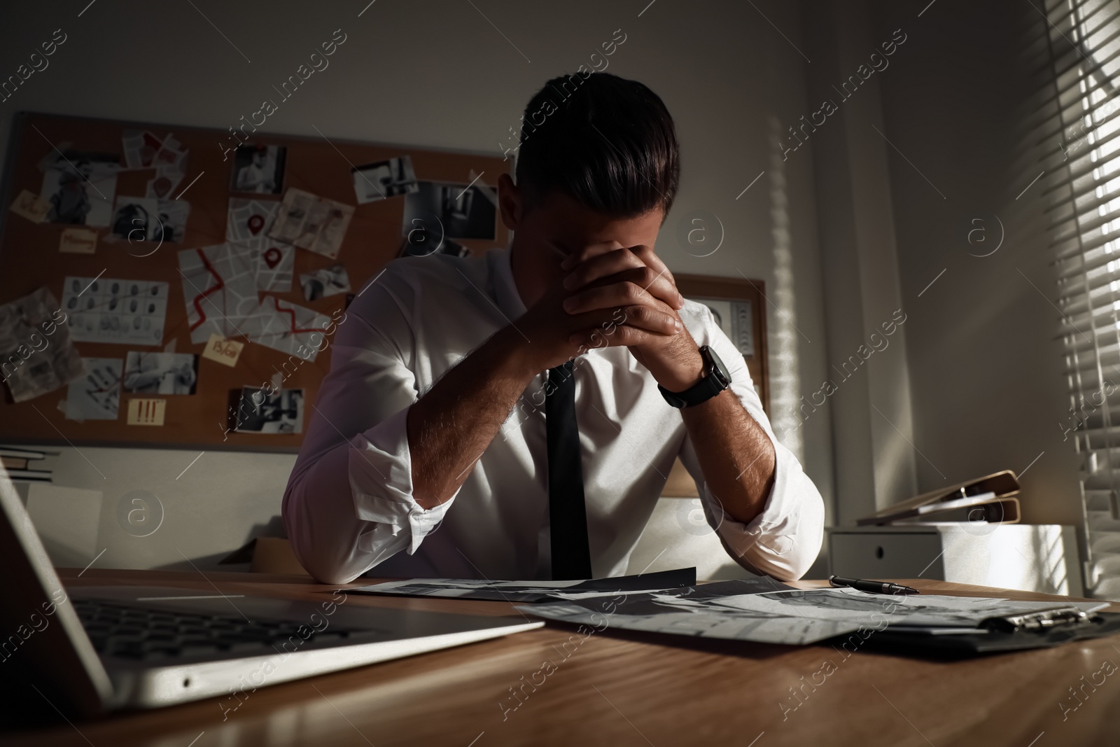 Photo of Detective working at desk in his office