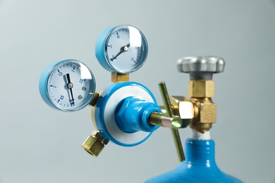 Photo of Pressure gauge of medical oxygen tank on light grey background, closeup