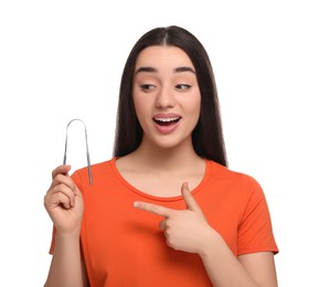 Emotional woman showing tongue cleaner on white background