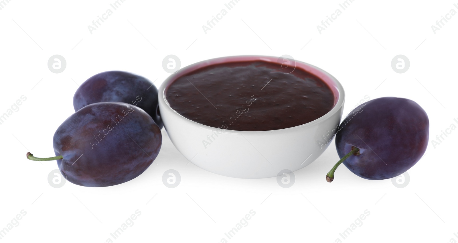 Photo of Plum puree in bowl and fresh fruits on white background