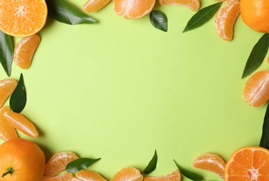 Composition with tangerines and leaves on color background, flat lay. Space for text