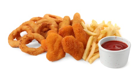 Different delicious fast food served with ketchup on white background