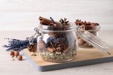 Photo of Aroma potpourri with different spices on white wooden table