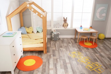 Photo of Yellow hopscotch floor sticker in bedroom at home