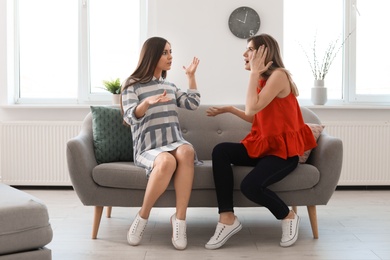 Photo of Women arguing on sofa at home