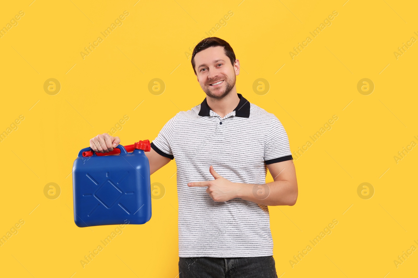 Photo of Man pointing at blue canister on orange background