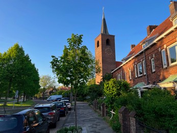 Beautiful view of city street with old tower on sunny morning