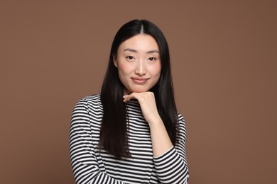 Portrait of beautiful woman on brown background