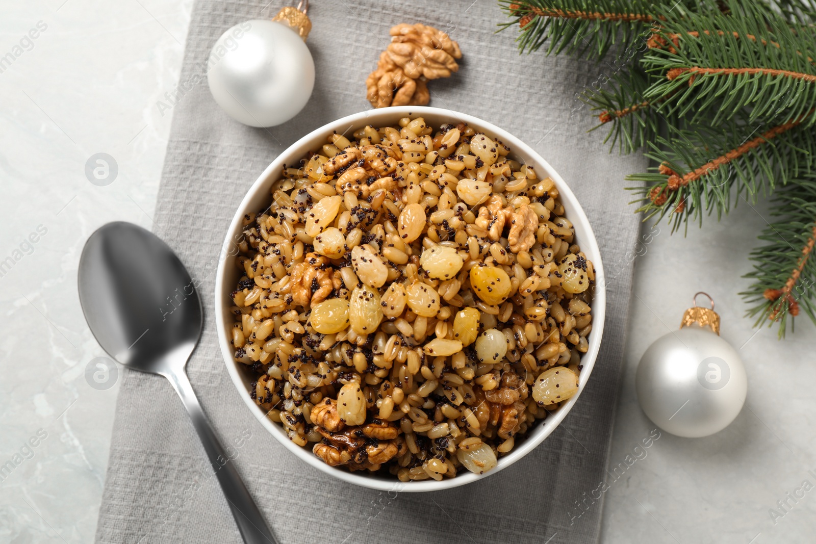 Photo of Traditional Christmas slavic dish kutia served on grey marble table, flat lay