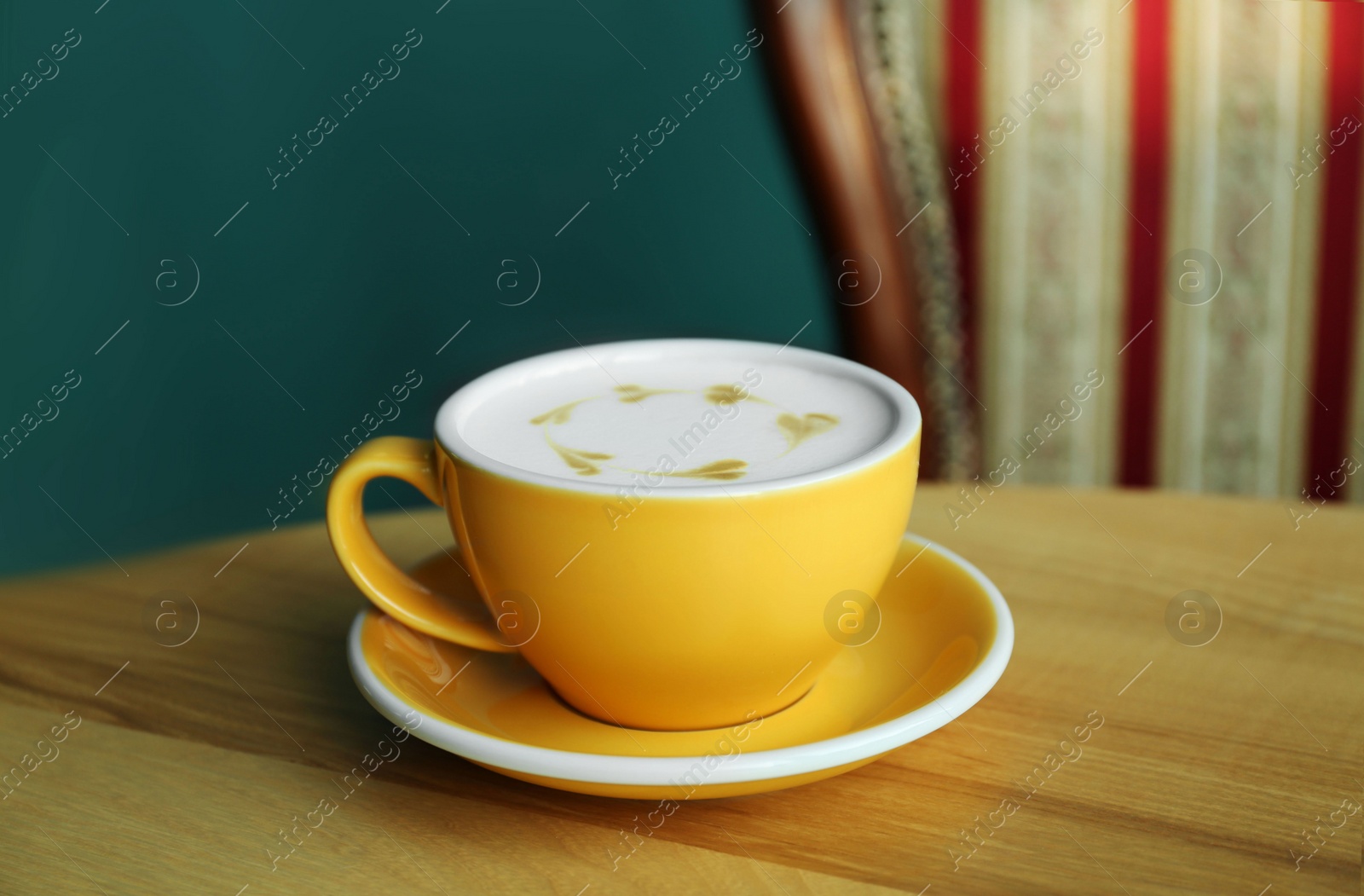 Photo of Cup of delicious coffee on wooden table indoors, closeup