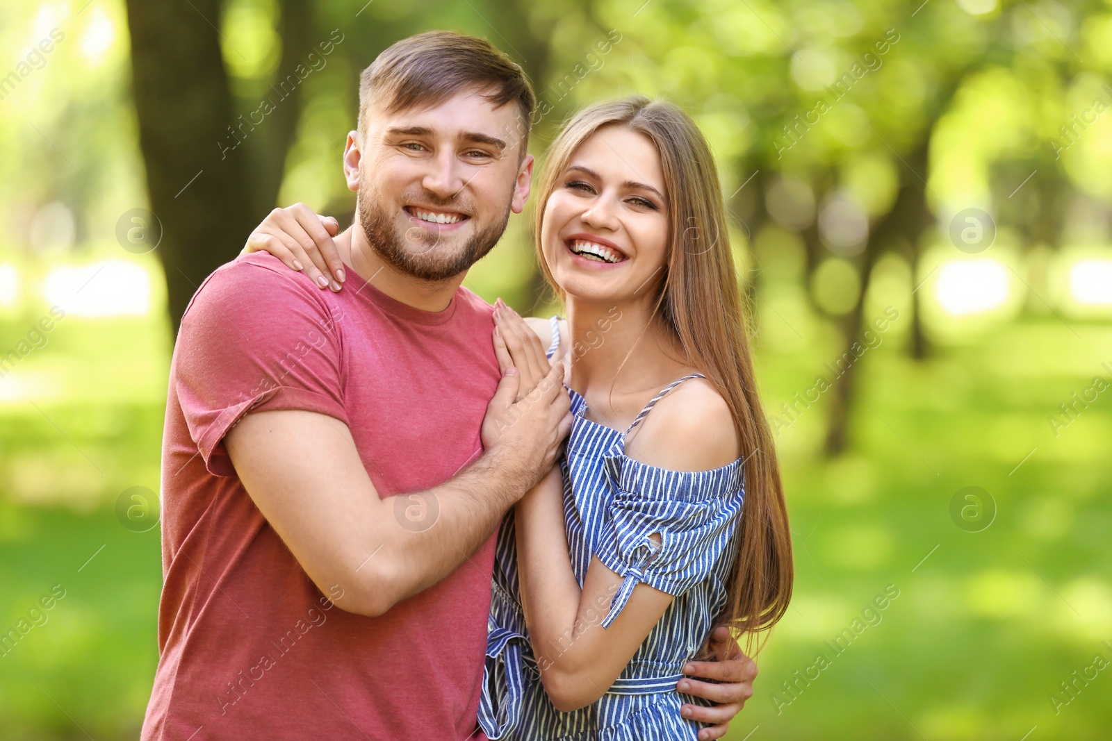 Photo of Happy young couple in green park on sunny spring day