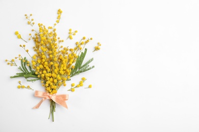 Bouquet of beautiful mimosa flowers on white background, top view