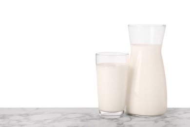 Photo of Glassware with tasty milk on marble table against white background
