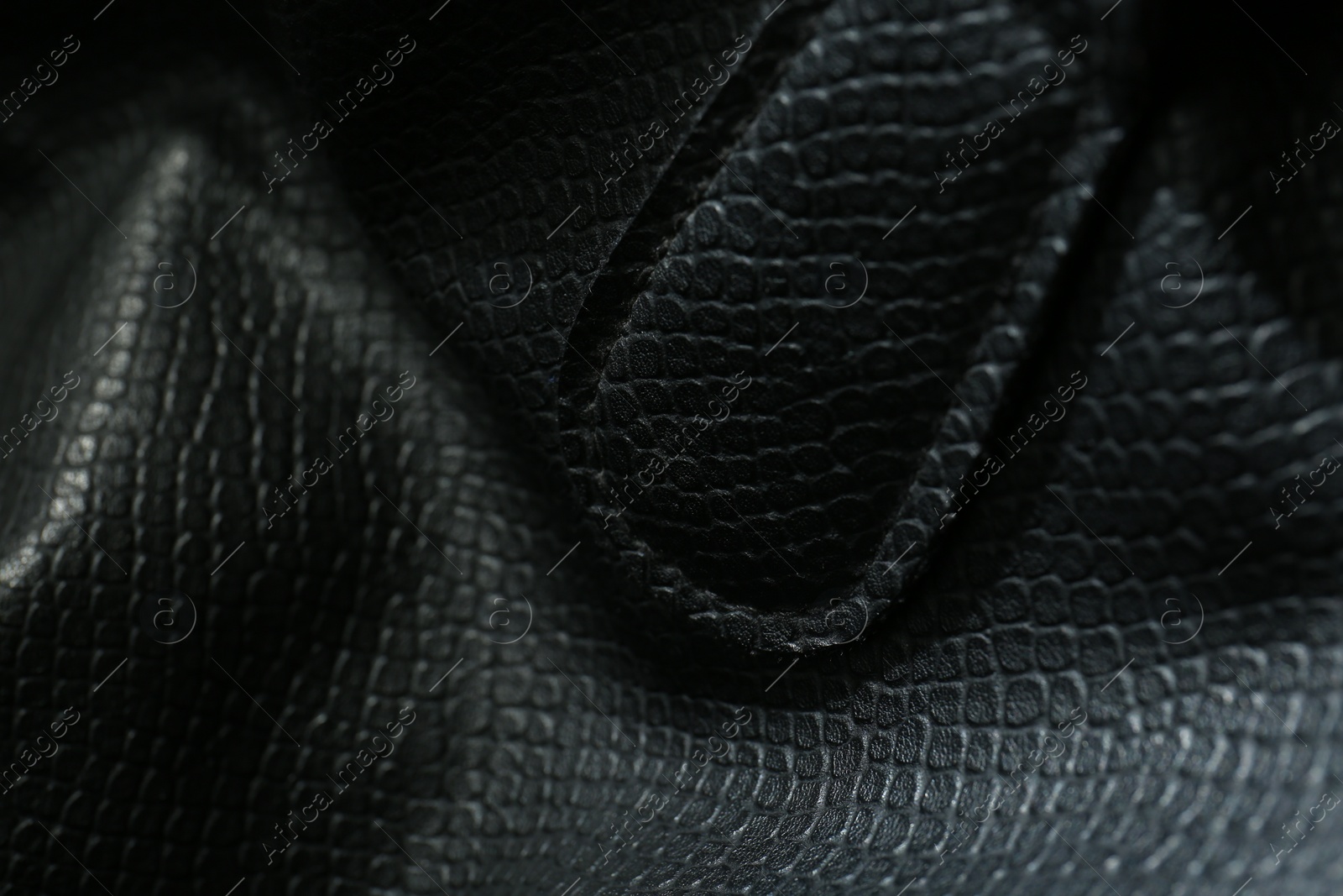 Photo of Black natural leather as background, closeup view