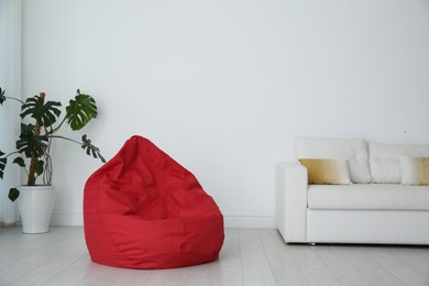 Photo of Red bean bag chair on floor in room