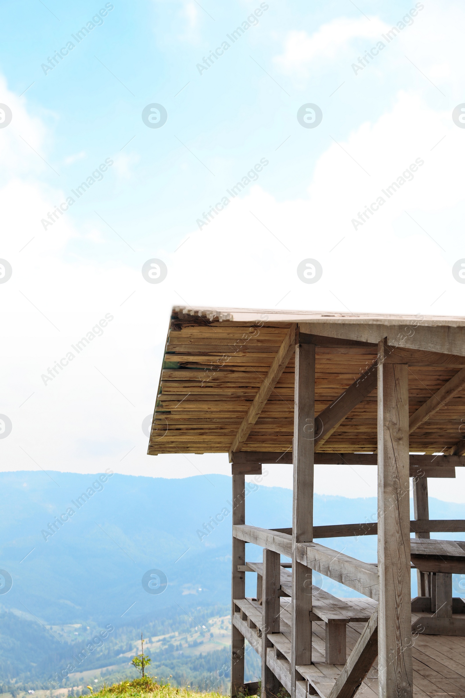 Photo of Picturesque landscape with wooden gazebo and mountain forest on background