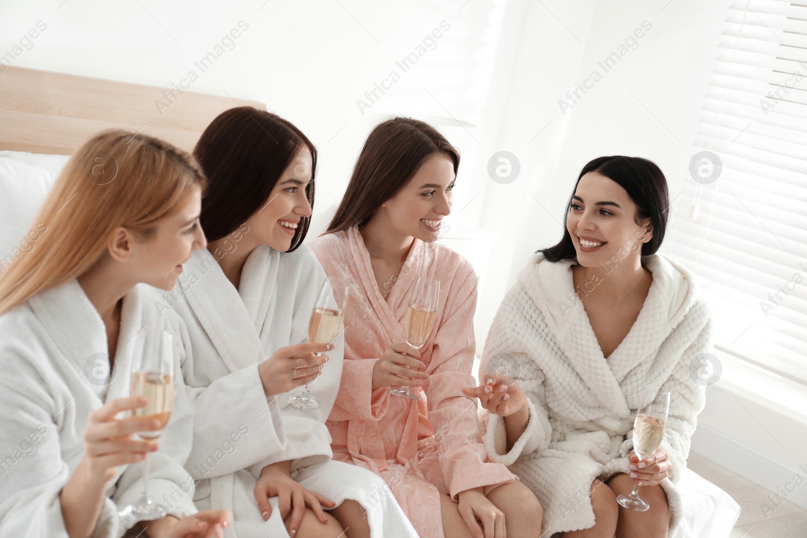 Photo of Beautiful young ladies with champagne at pamper party. Women's Day