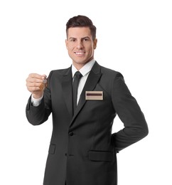 Photo of Happy receptionist in uniform holding key on white background