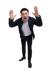 Photo of Angry businessman in suit screaming on white background, low angle view