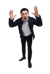 Angry businessman in suit screaming on white background, low angle view