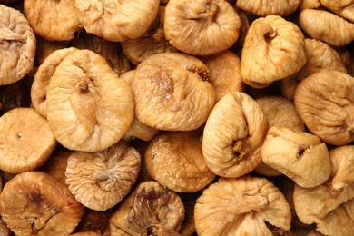 Photo of Many tasty dried figs as background, top view