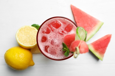 Delicious fresh watermelon drink on white wooden table, flat lay