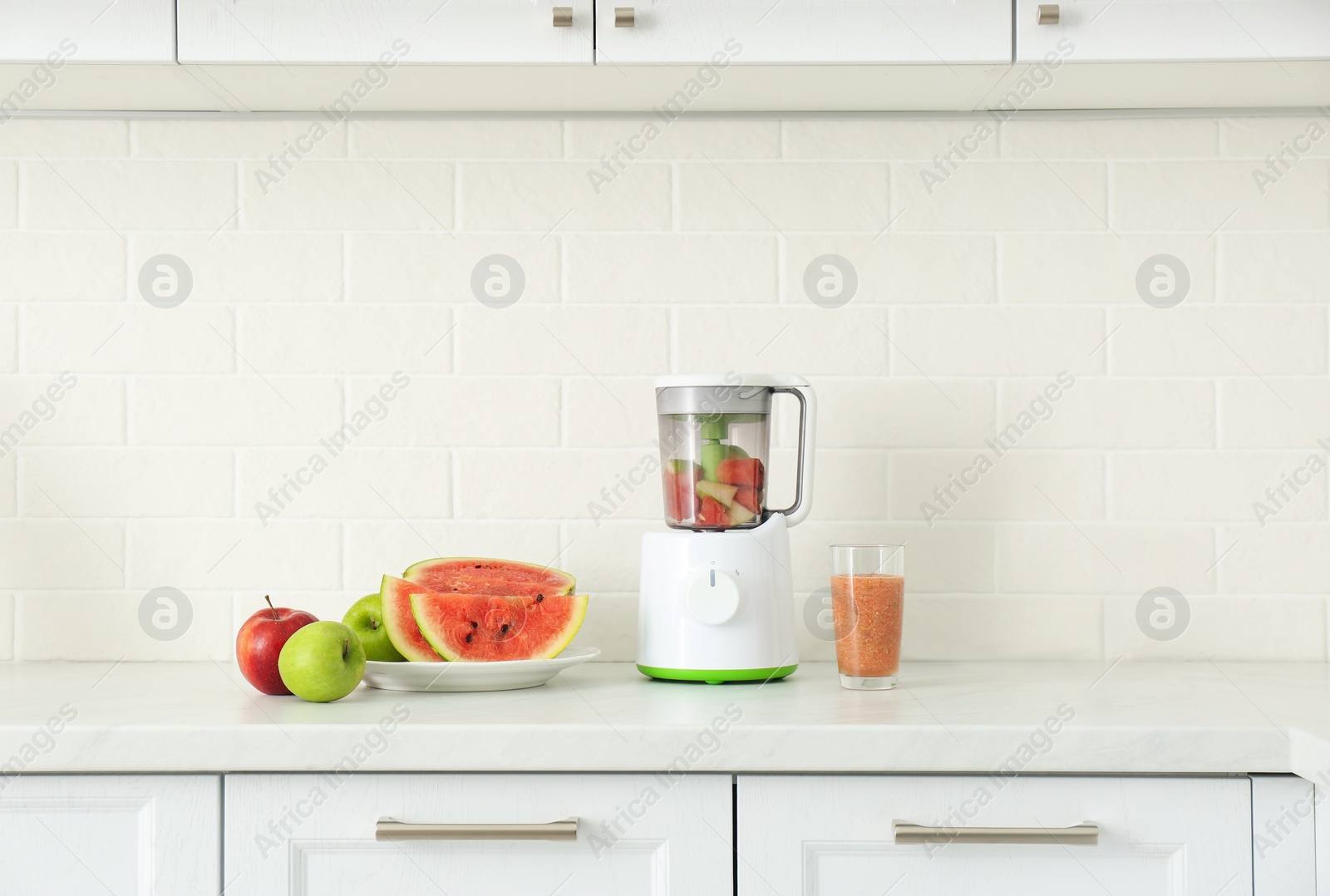 Photo of Blender and smoothie ingredients on counter in kitchen