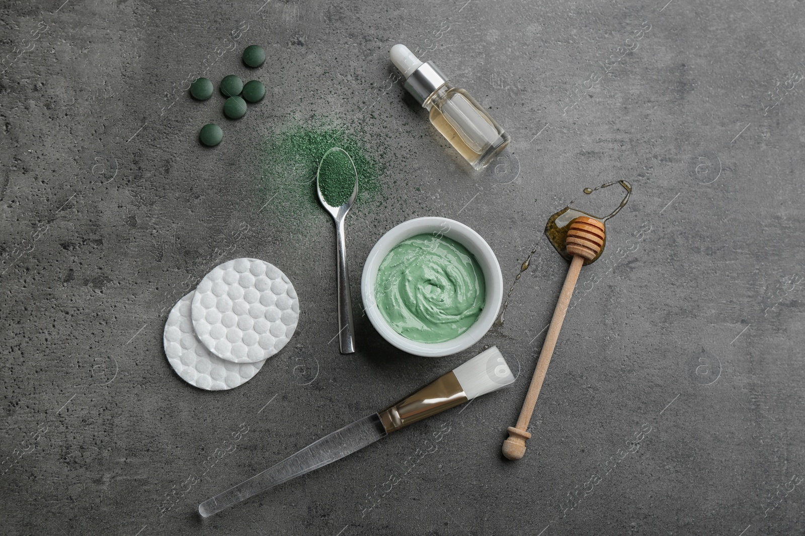 Photo of Flat lay composition with spirulina facial mask and ingredients on grey table