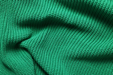 Texture of soft green fabric as background, top view